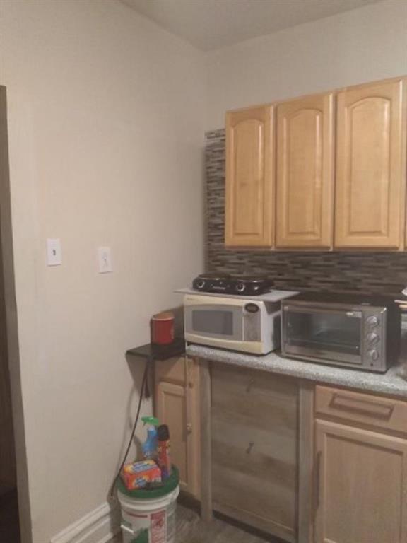 1772 Nostrand Avenue Brooklyn, NY 11226 - Photo 7 of 22 a kitchen with a stove and a microwave
