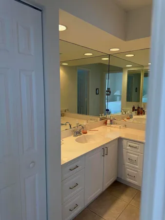 a bathroom with a double vanity sink and mirror