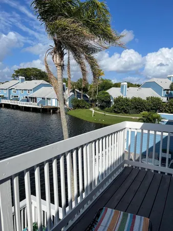a view of a wooden deck with chairs