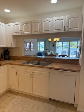 a kitchen with granite countertop a sink and cabinets