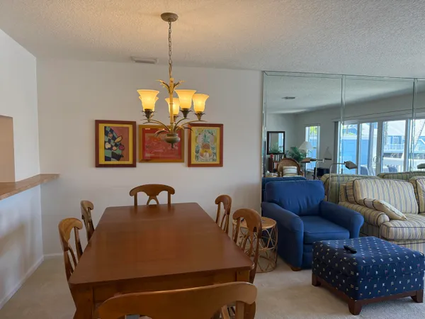 a dining room with furniture and a chandelier