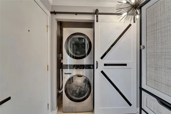 a kitchen with granite countertop a sink stainless steel appliances and white cabinets
