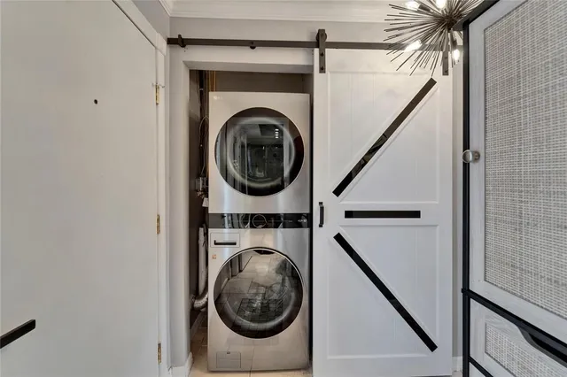 a kitchen with granite countertop a sink stainless steel appliances and white cabinets