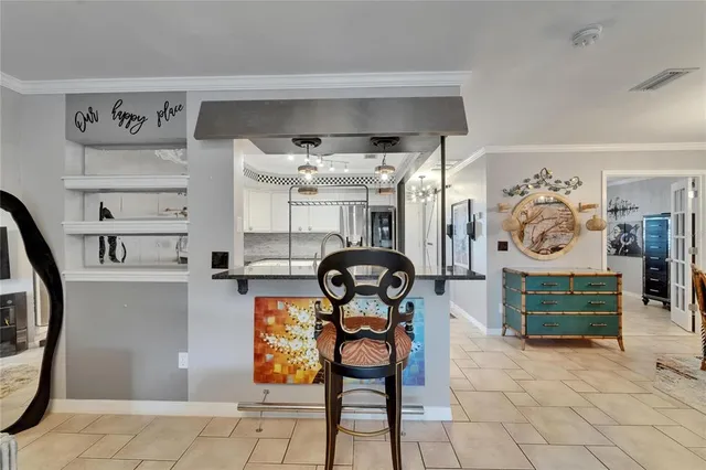 a view of a dining room with furniture and chandelier