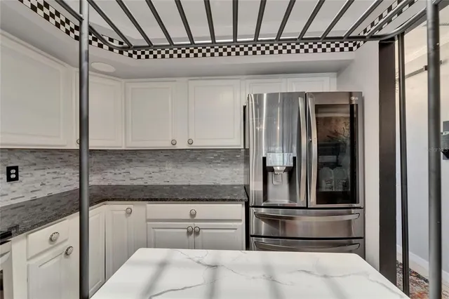 a view of a dining room with furniture and a chandelier
