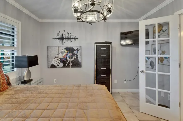 a bedroom with a bed and a television