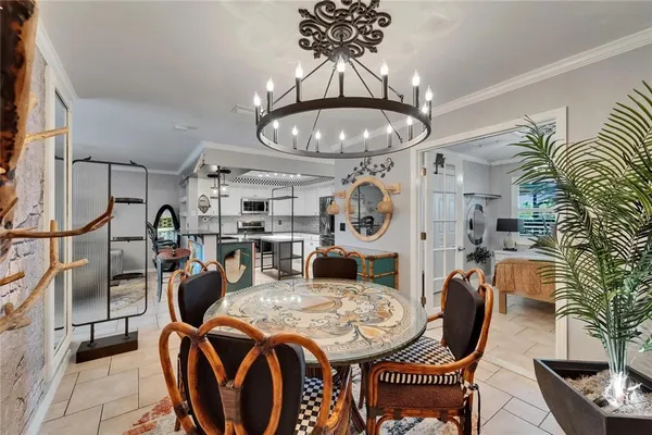 a living room with furniture and a chandelier