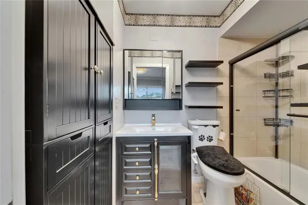 a view of a patio with table and chairs potted plants and a large tree