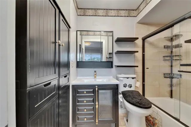 a view of a patio with table and chairs potted plants and a large tree