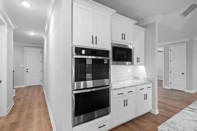 a kitchen with stainless steel appliances a stove microwave and cabinets