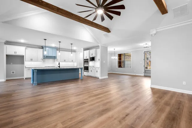 a view of a kitchen with a sink and a refrigerator