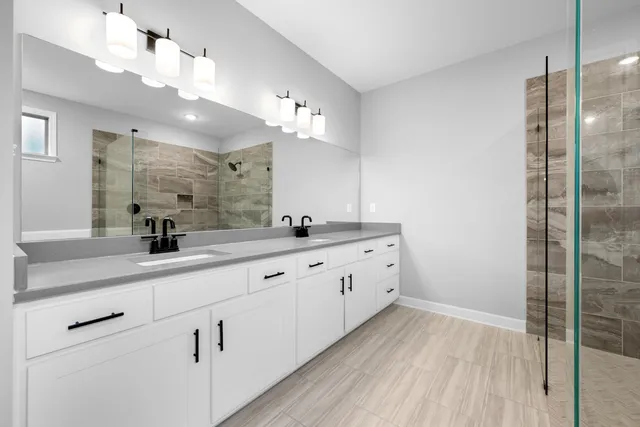 a bathroom with double vanity sink and mirror