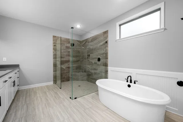 a bathroom with a bathtub and a shower