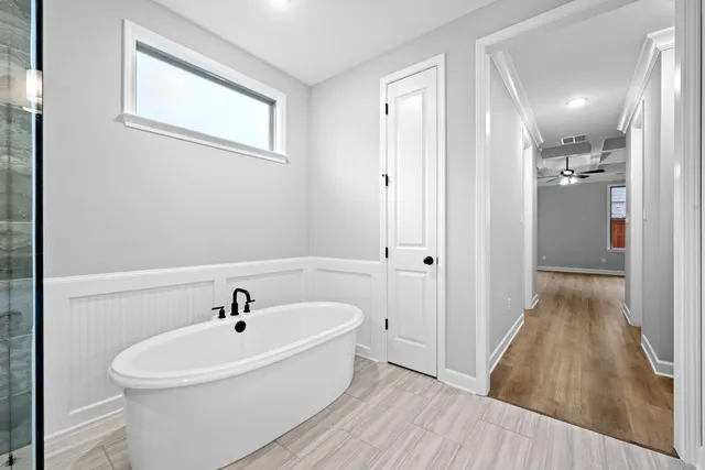 a white bath tub sitting next to a bathroom sink