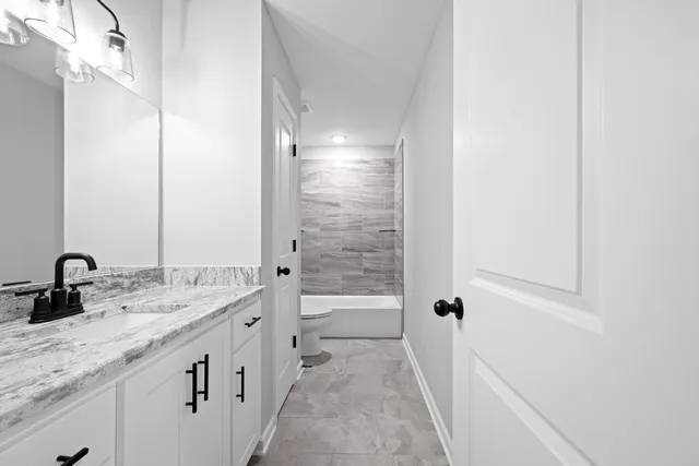 a bathroom with a double vanity sink and a bathtub