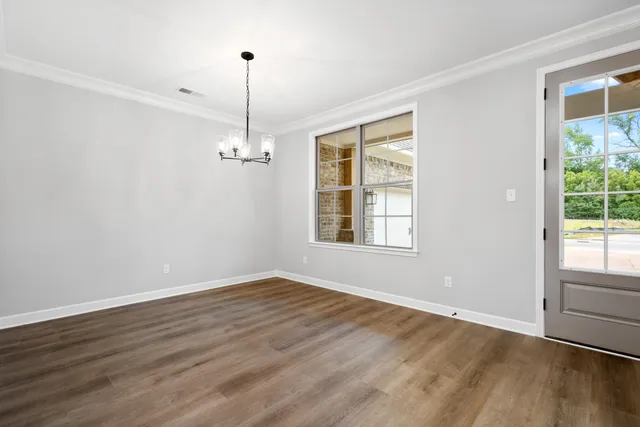 a view of an empty room with a window and a fireplace