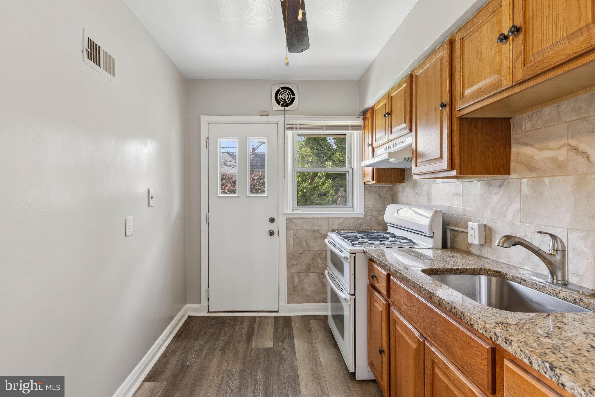 1581 Stonewood Road Baltimore, MD 21239 - Photo 12 of 21 a kitchen that has a sink a stove and a window