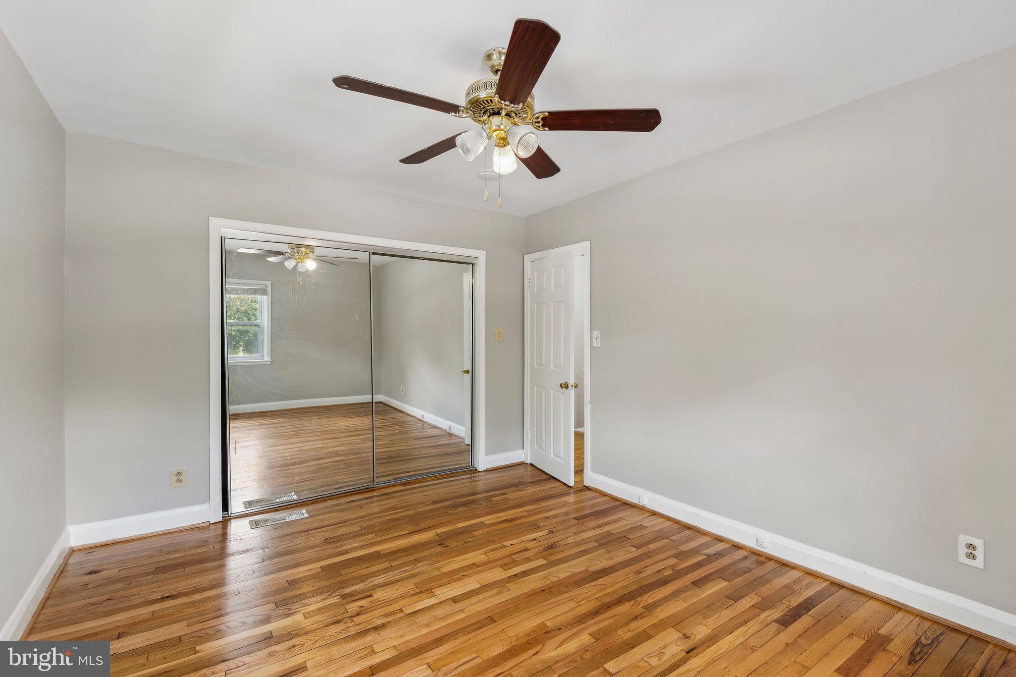 1581 Stonewood Road Baltimore, MD 21239 - Photo 14 of 21 a view of empty room with wooden floor