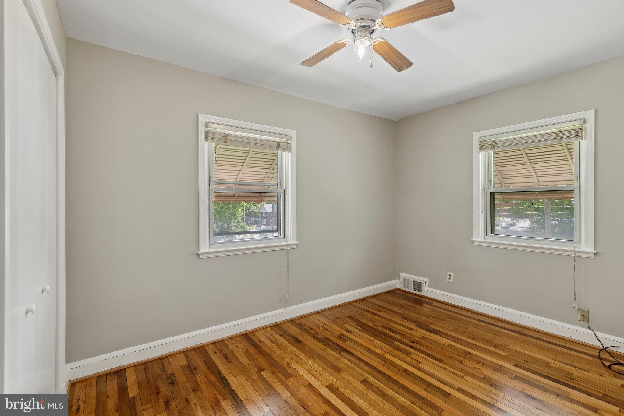 1581 Stonewood Road Baltimore, MD 21239 - Photo 15 of 21 a view of an empty room with wooden floor and a window