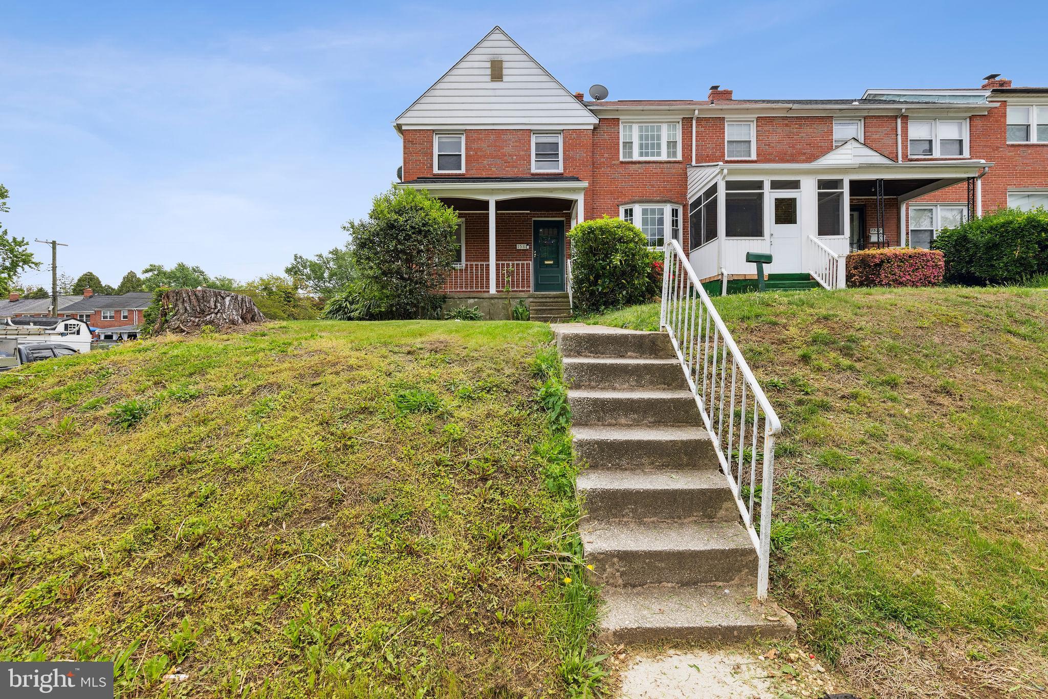 1581 Stonewood Road Baltimore, MD 21239 - Photo 2 of 21 a front view of a house with a yard