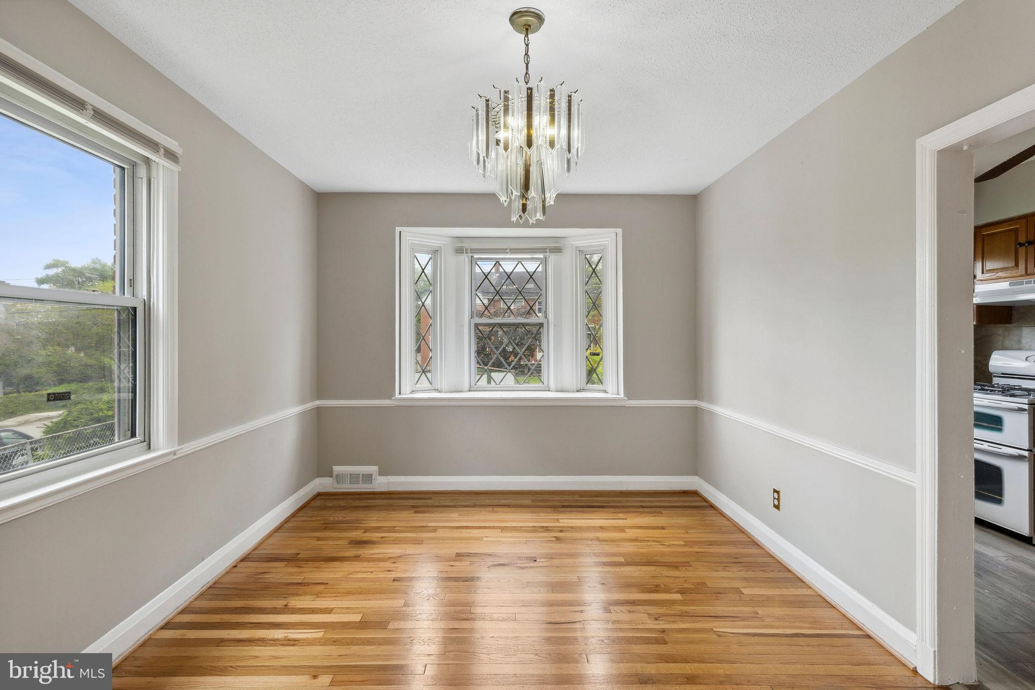 1581 Stonewood Road Baltimore, MD 21239 - Photo 9 of 21 a view of empty room with wooden floor and fan