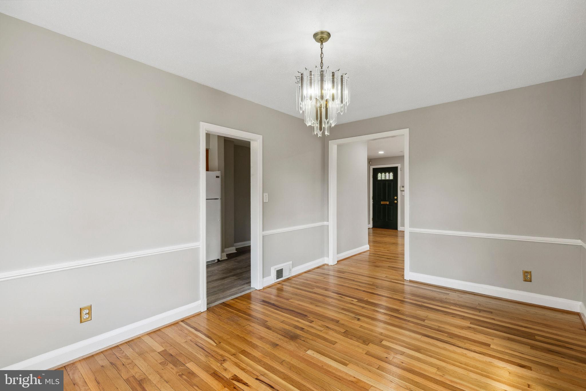 1581 Stonewood Road Baltimore, MD 21239 - Photo 10 of 21 a view of livingroom with hardwood floor and kitchen view