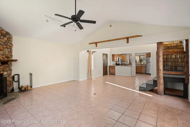 a living room with furniture and kitchen view