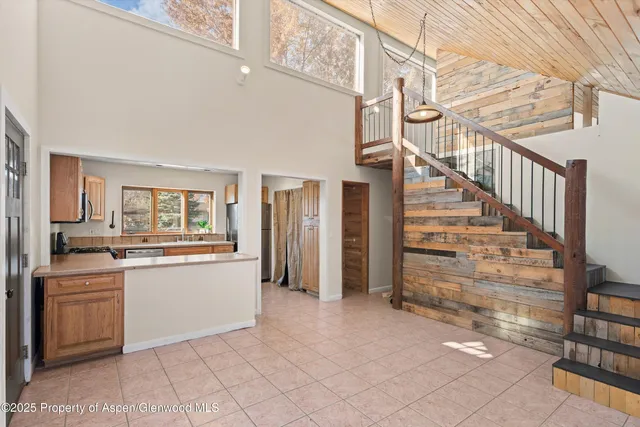 a kitchen with granite countertop a refrigerator and a stove