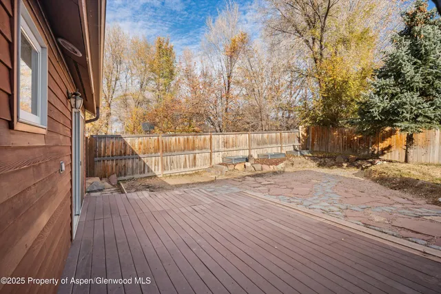 a view of backyard with a house and wooden floor