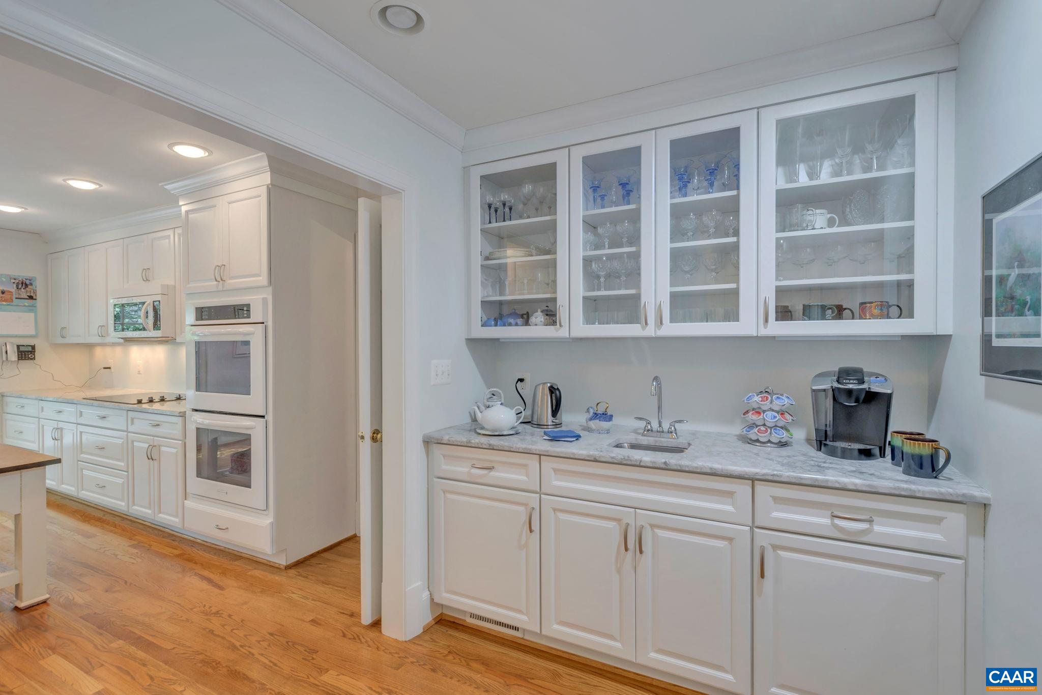 1440 Grove Road Charlottesville, VA 22901 - Photo 16 of 72 a kitchen with a sink cabinets and wooden floor