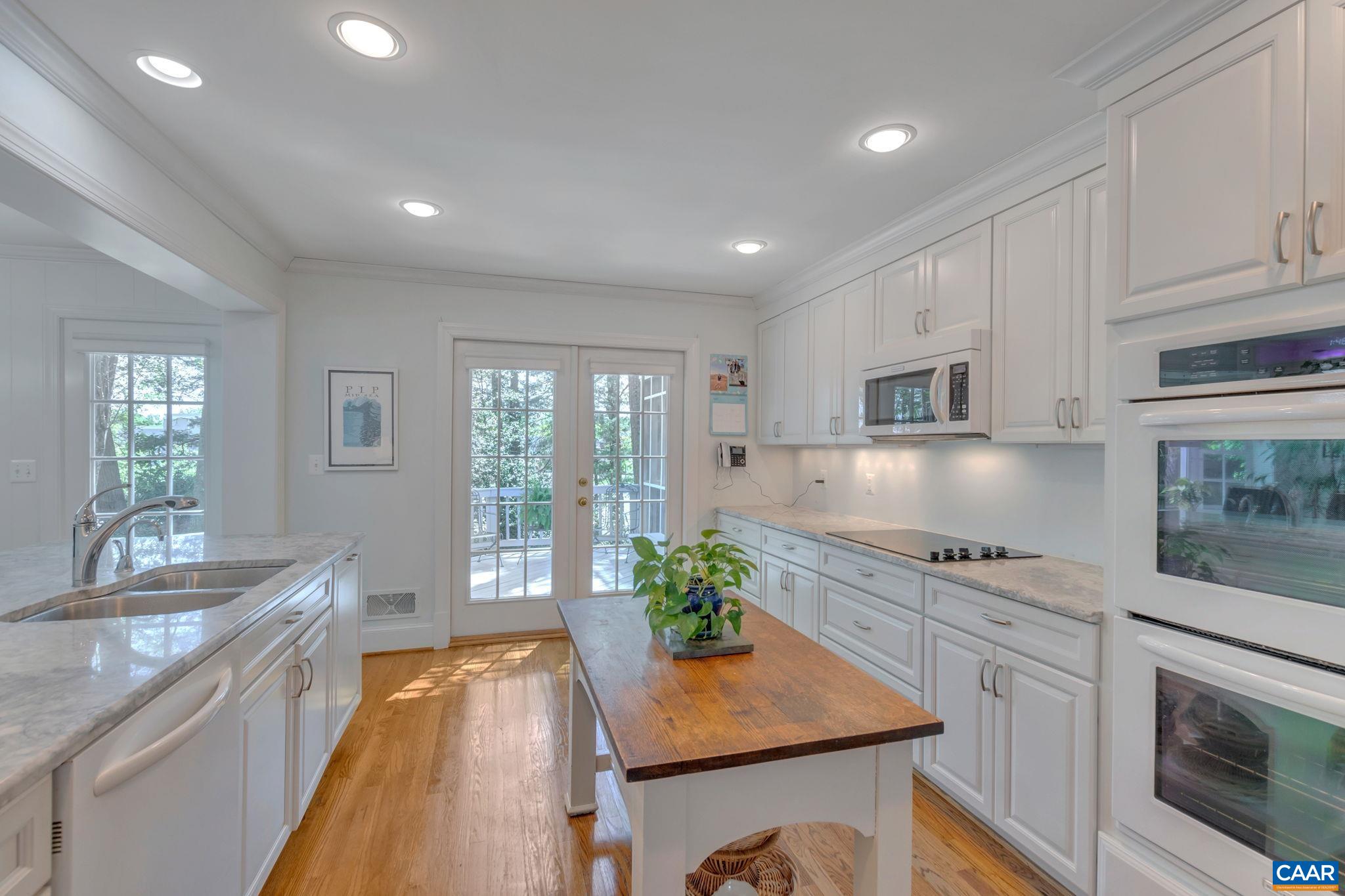 1440 Grove Road Charlottesville, VA 22901 - Photo 17 of 72 a kitchen with stainless steel appliances granite countertop a sink a stove a refrigerator cabinets and living room view