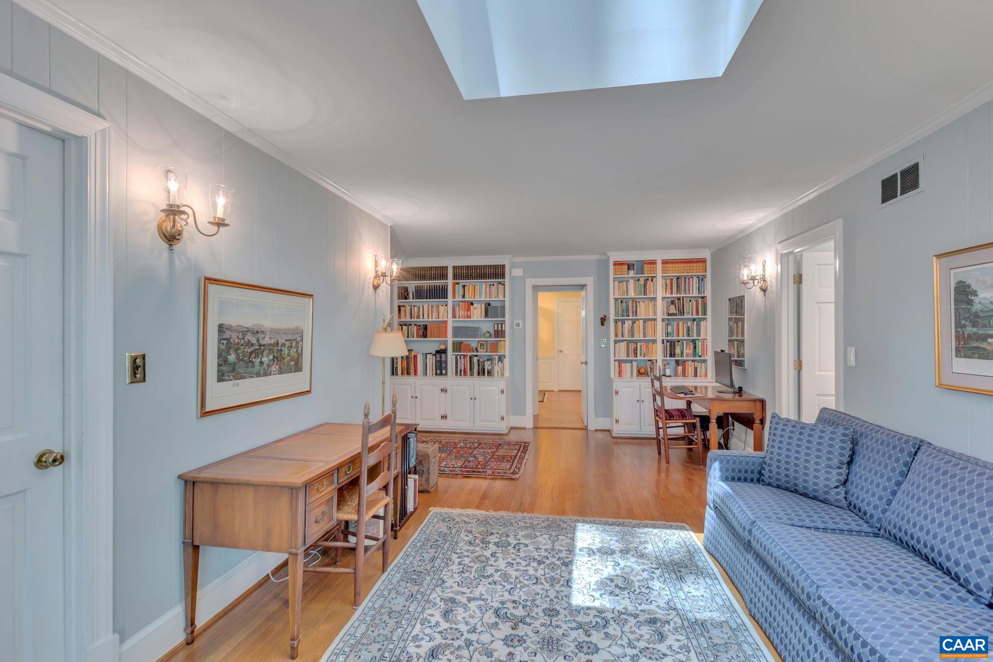 1440 Grove Road Charlottesville, VA 22901 - Photo 25 of 72 a living room with furniture and a book shelf