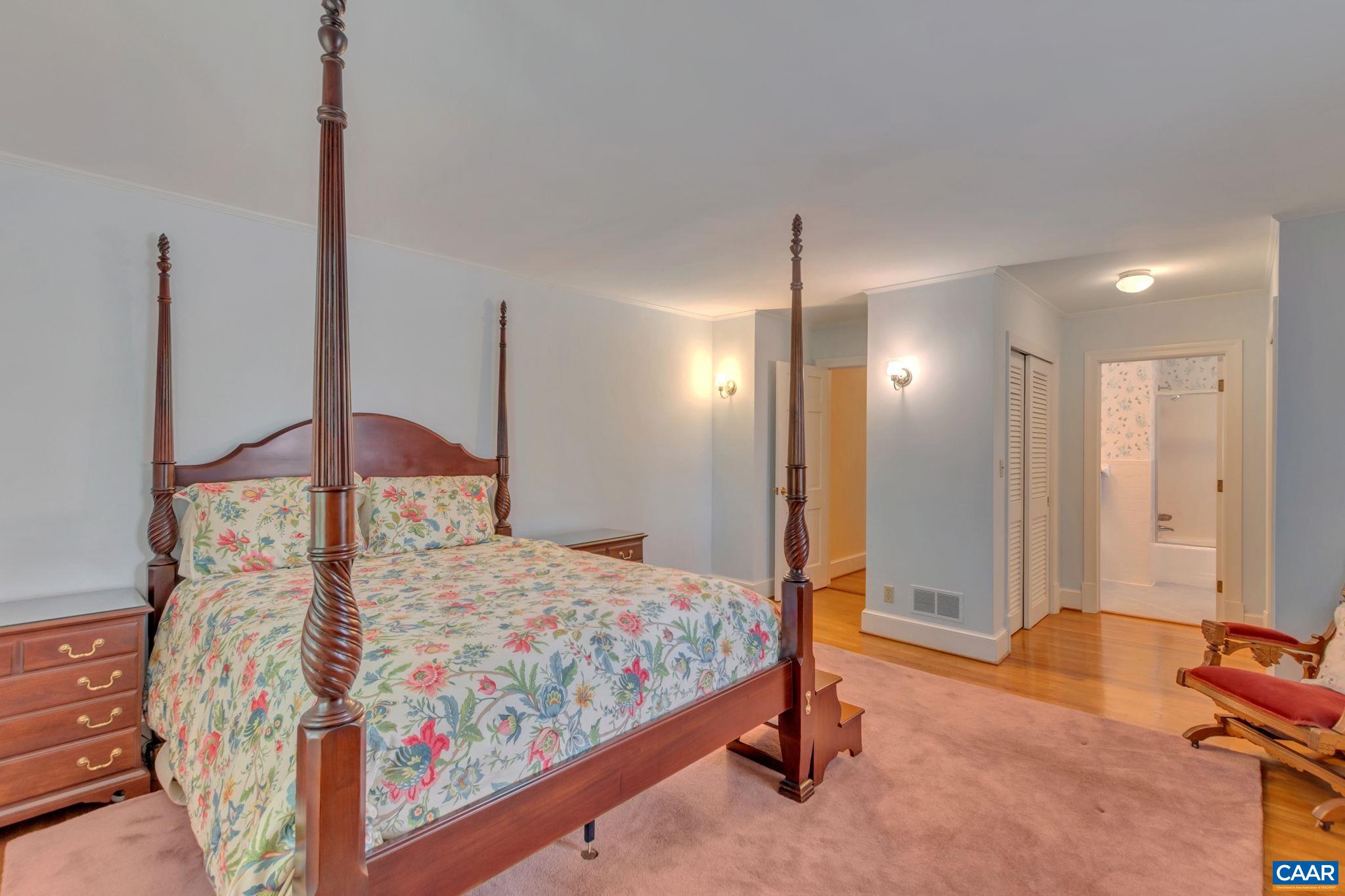 1440 Grove Road Charlottesville, VA 22901 - Photo 35 of 72 a bedroom with a bed and a chandelier