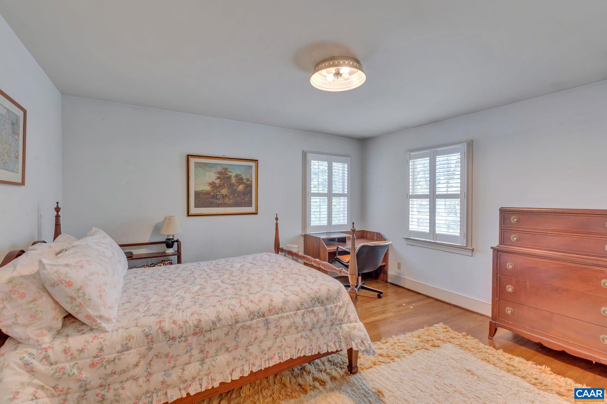 1440 Grove Road Charlottesville, VA 22901 - Photo 39 of 72 a bedroom with a bed and wooden floor