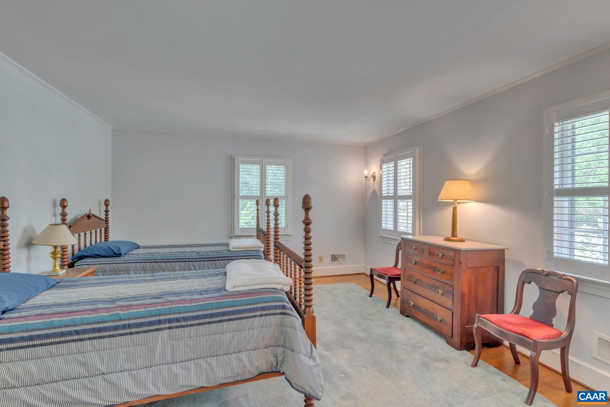 1440 Grove Road Charlottesville, VA 22901 - Photo 40 of 72 a bedroom with furniture and a lamp
