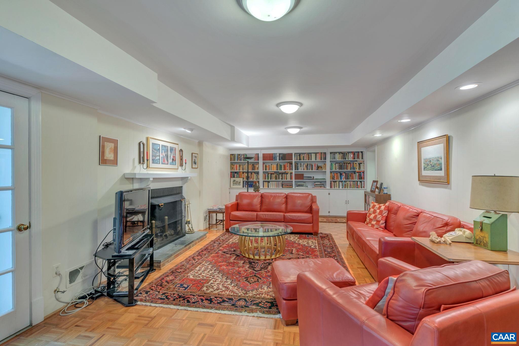 1440 Grove Road Charlottesville, VA 22901 - Photo 43 of 72 a living room with furniture fireplace and a flat screen tv