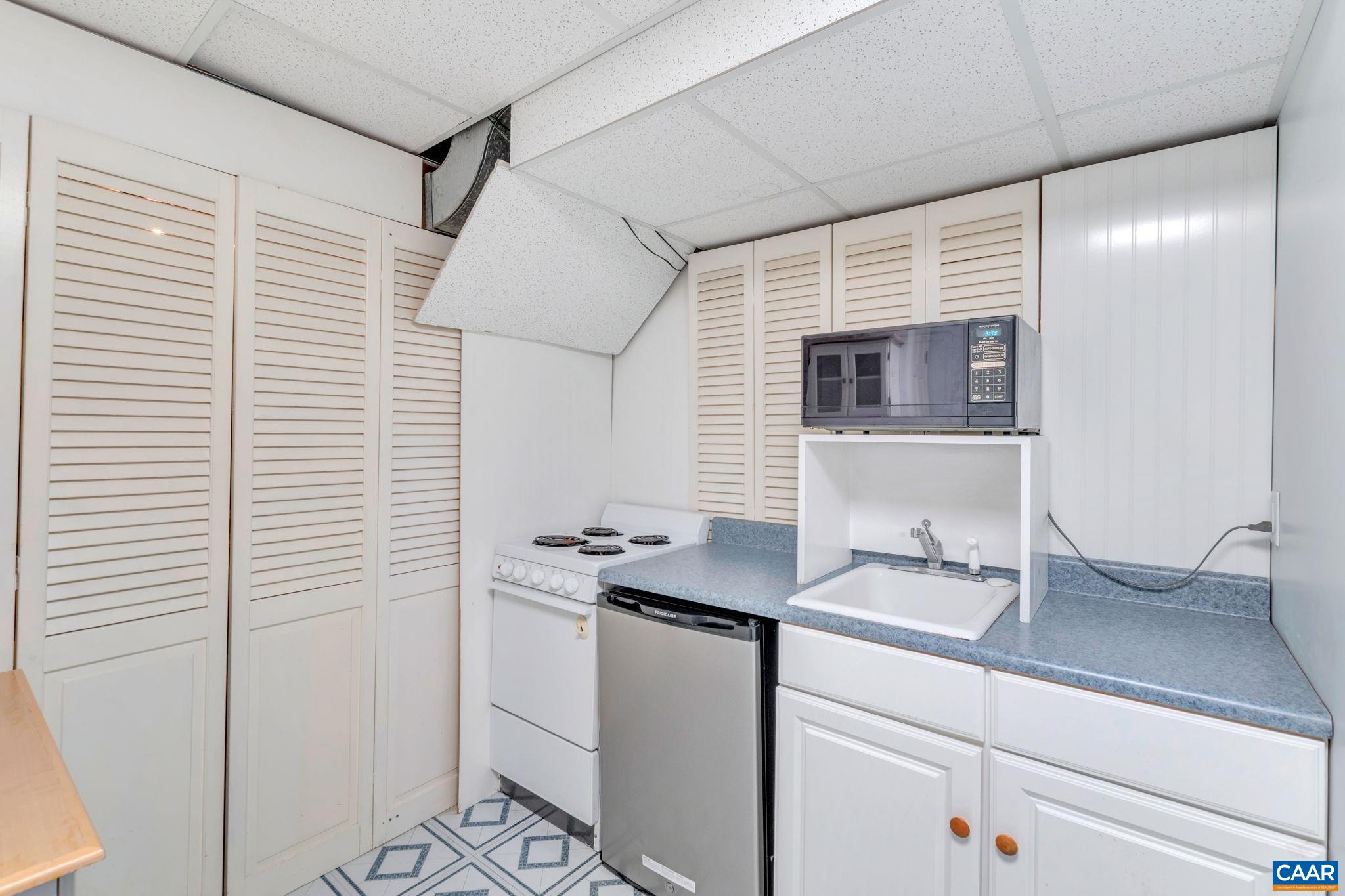 1440 Grove Road Charlottesville, VA 22901 - Photo 47 of 72 a bathroom with a sink and a mirror