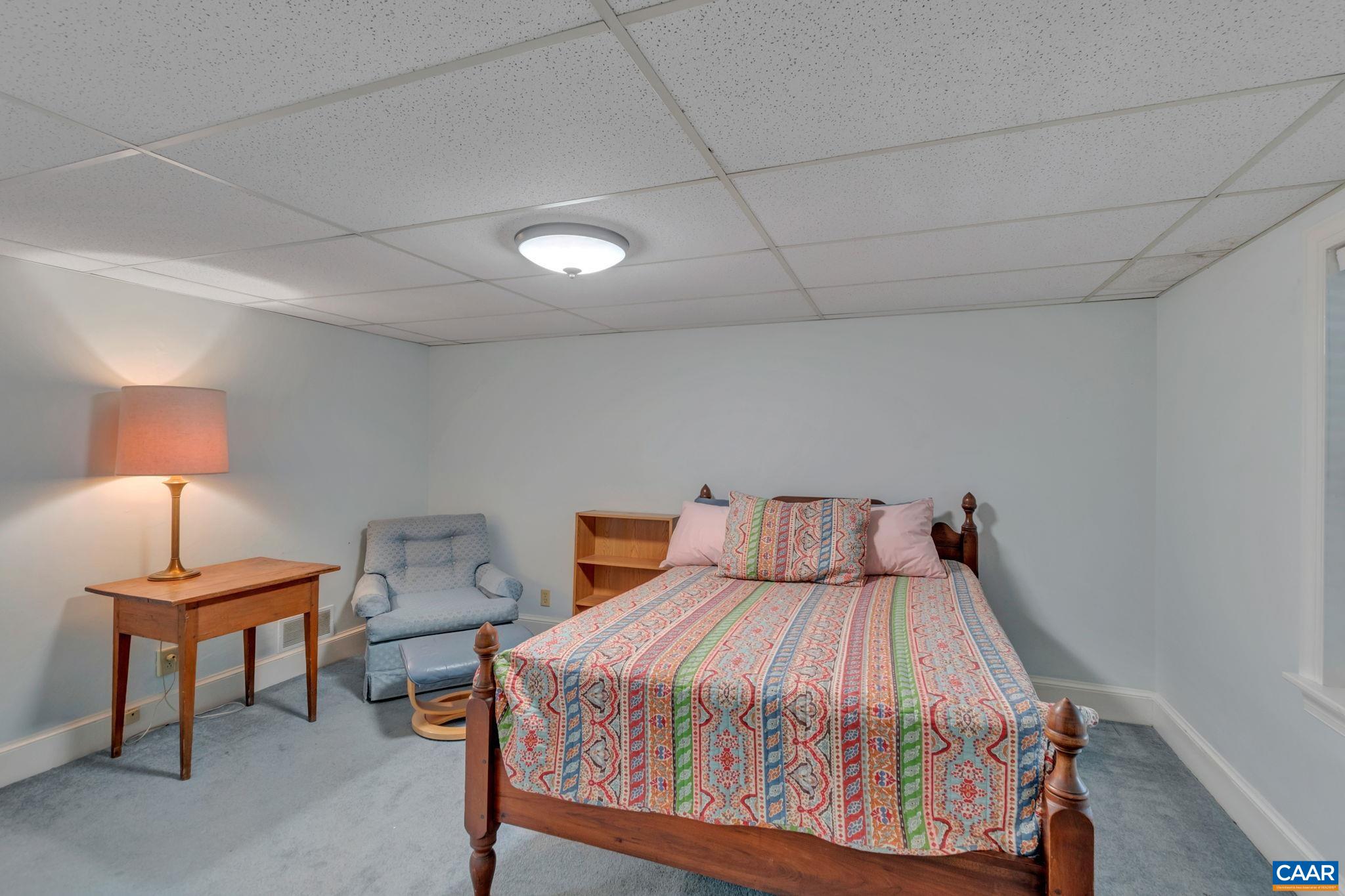 1440 Grove Road Charlottesville, VA 22901 - Photo 50 of 72 a bedroom with a bed and a lamp