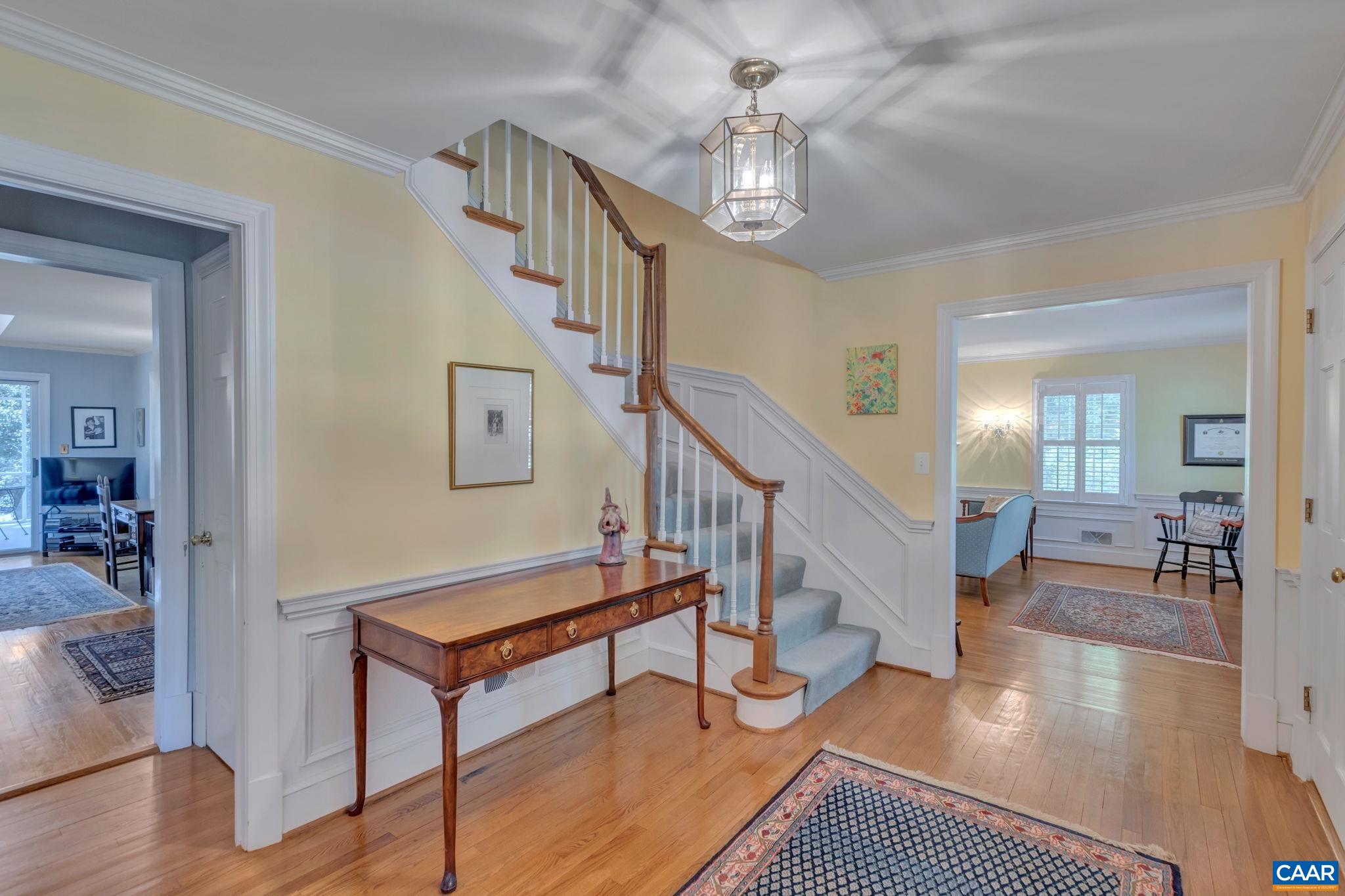 1440 Grove Road Charlottesville, VA 22901 - Photo 7 of 72 a living room with couches and paintings on the wall with wooden floor