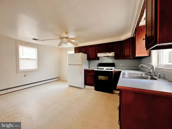 a kitchen with a refrigerator and a sink