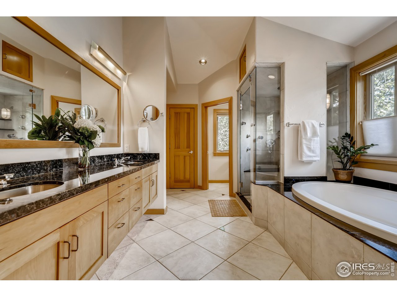 566 Dakota Boulevard Boulder, CO 80304 - Photo 15 of 24 a large white kitchen with stainless steel appliances granite countertop a sink and cabinets