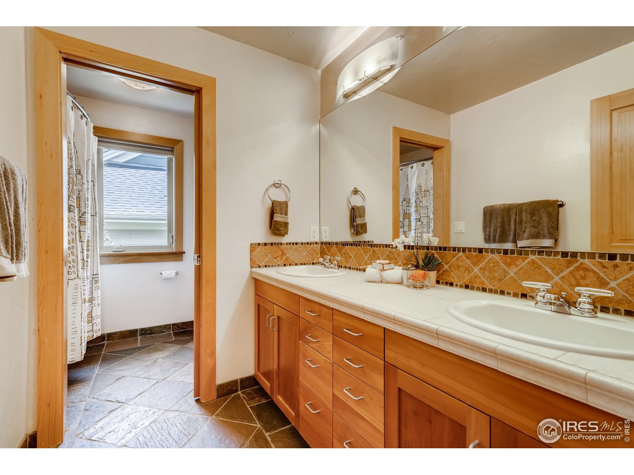 566 Dakota Boulevard Boulder, CO 80304 - Photo 19 of 24 a bathroom with a sink and a mirror