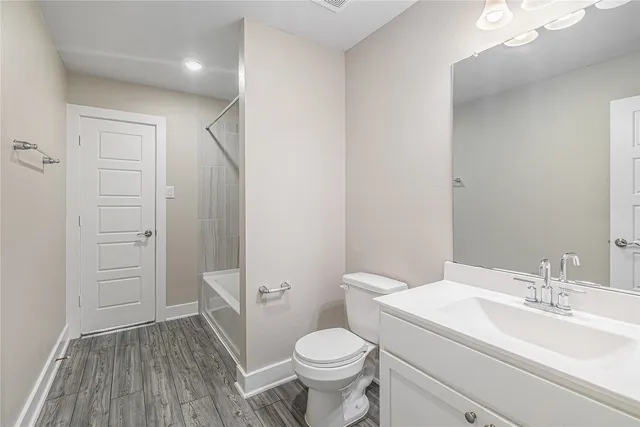 a white toilet sitting next to a bathroom sink