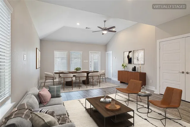 a living room with furniture a rug and a window