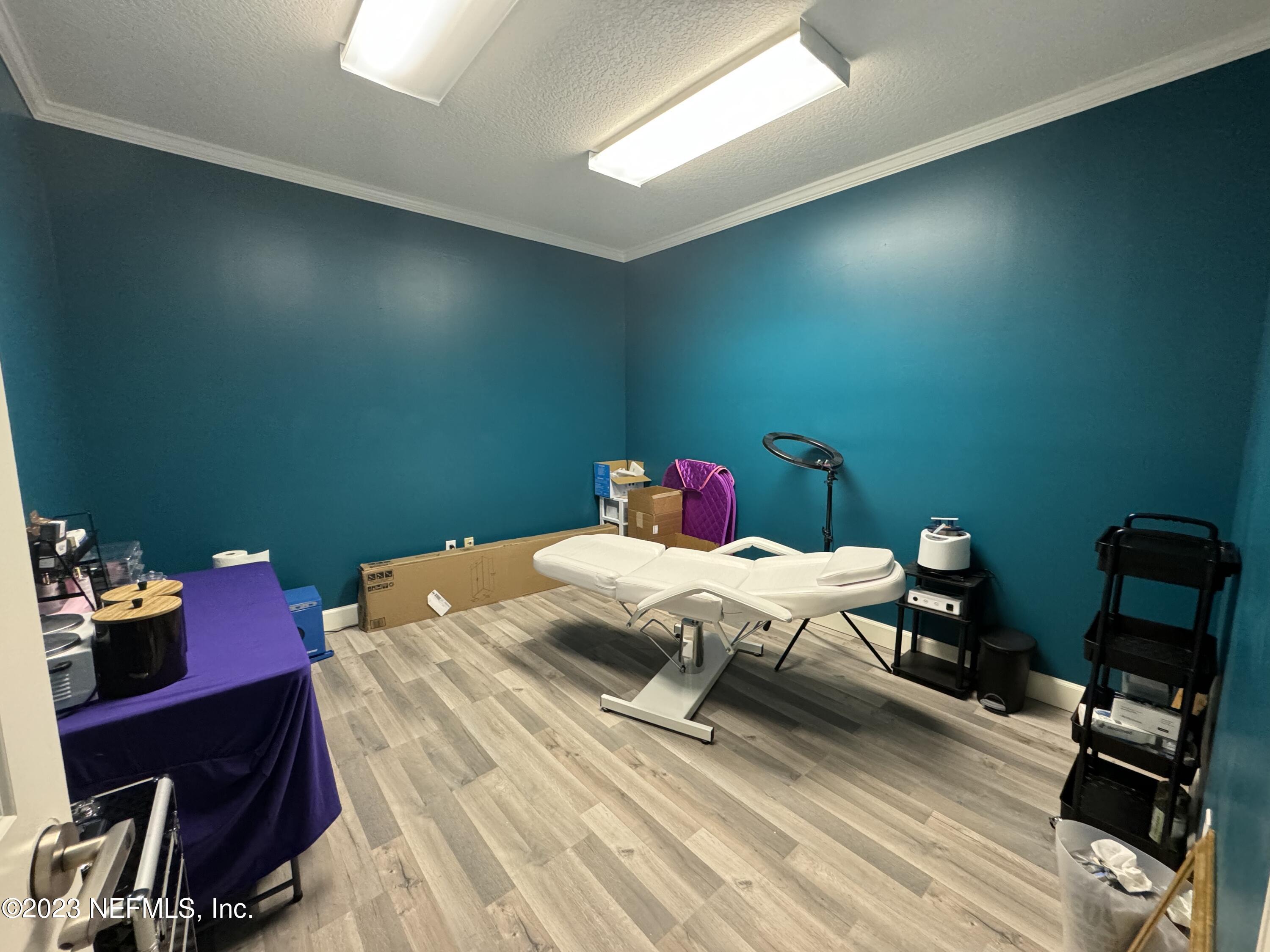 9905 Old St Augustine Road, Unit 502 Jacksonville, FL 32257 - Photo 11 of 12 a bed room with a bed and a chair