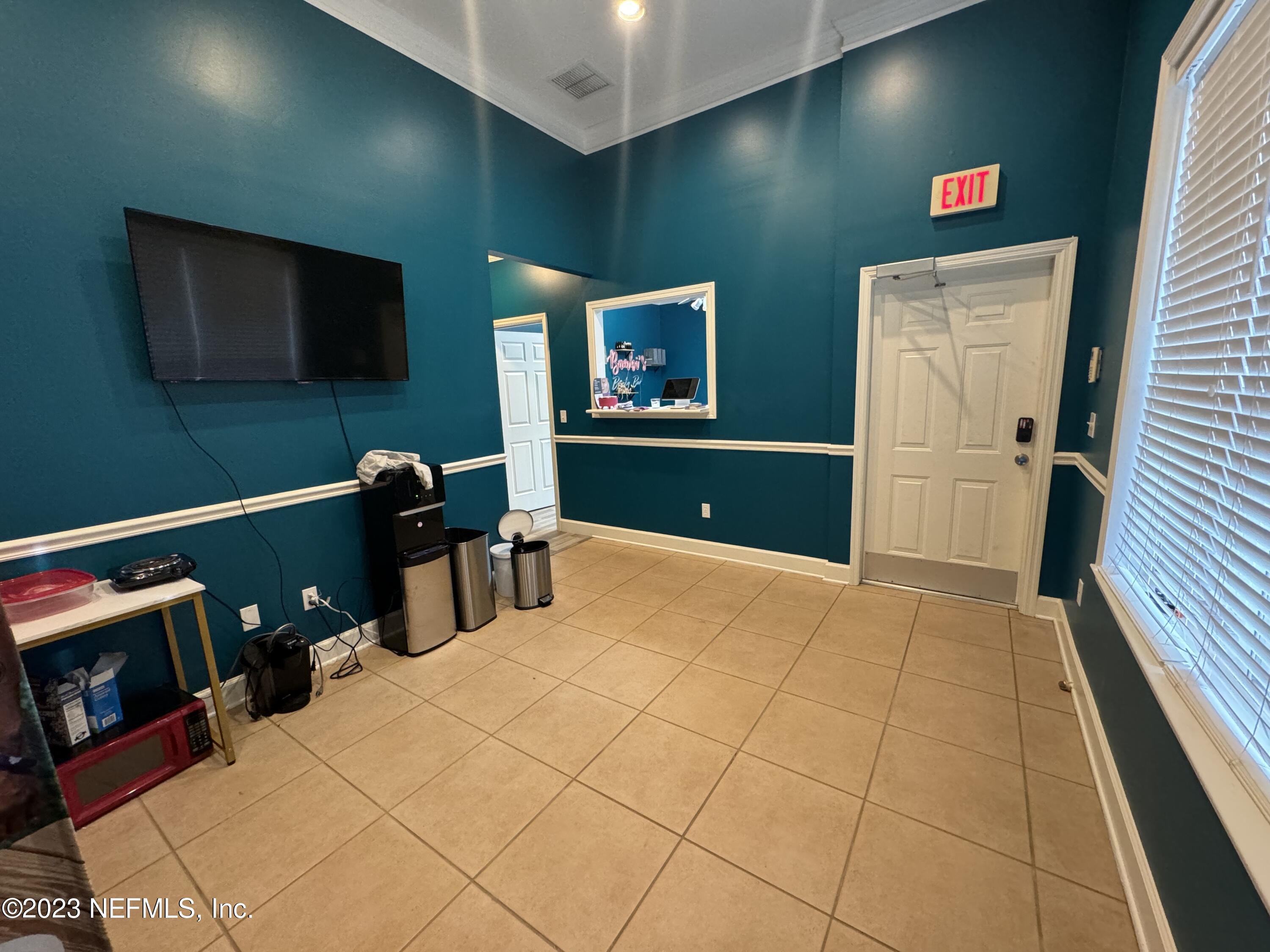 9905 Old St Augustine Road, Unit 502 Jacksonville, FL 32257 - Photo 3 of 12 a bedroom with a bed and a flat screen tv