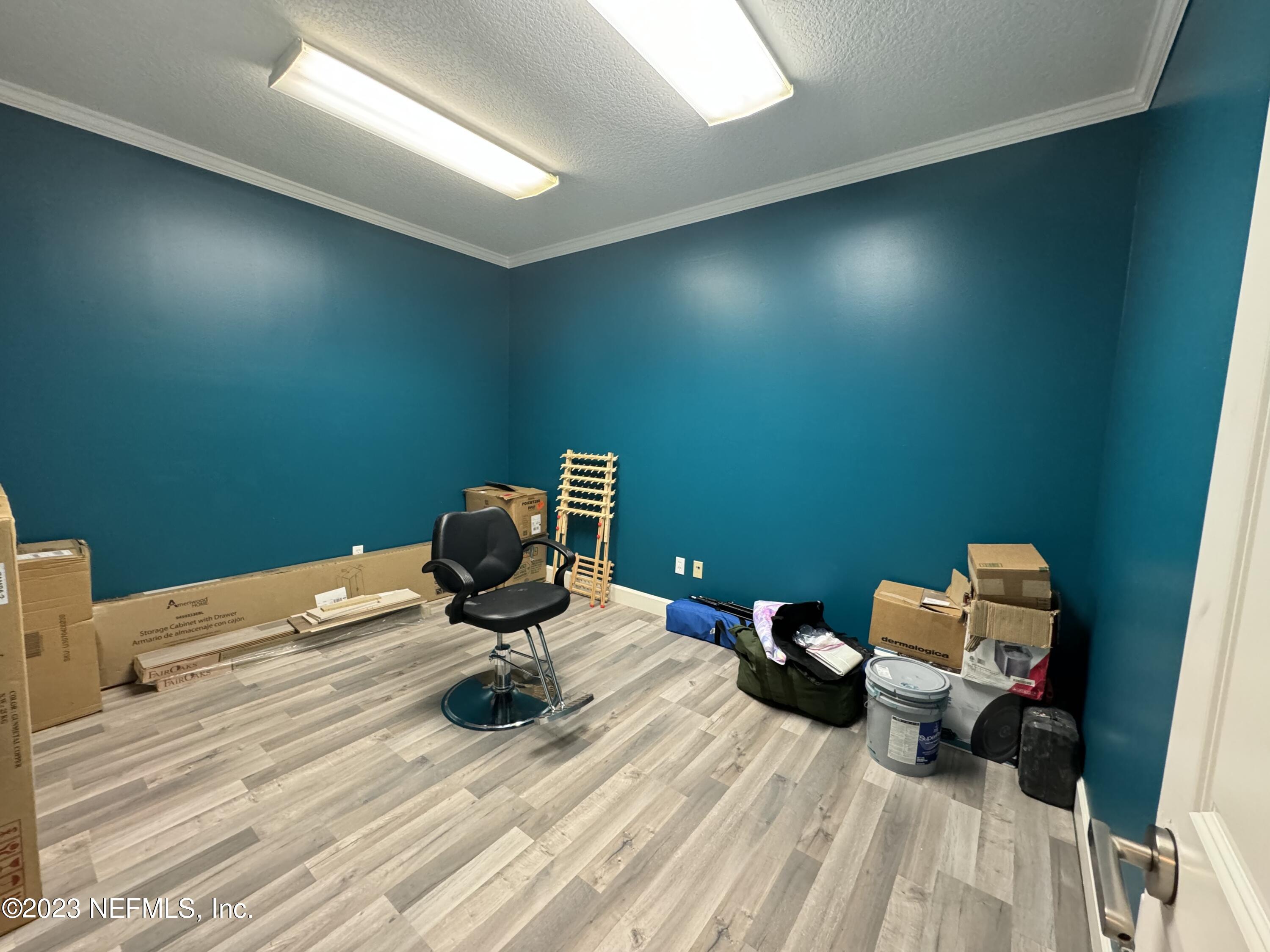 9905 Old St Augustine Road, Unit 502 Jacksonville, FL 32257 - Photo 6 of 12 a bedroom with a bed and wooden floor