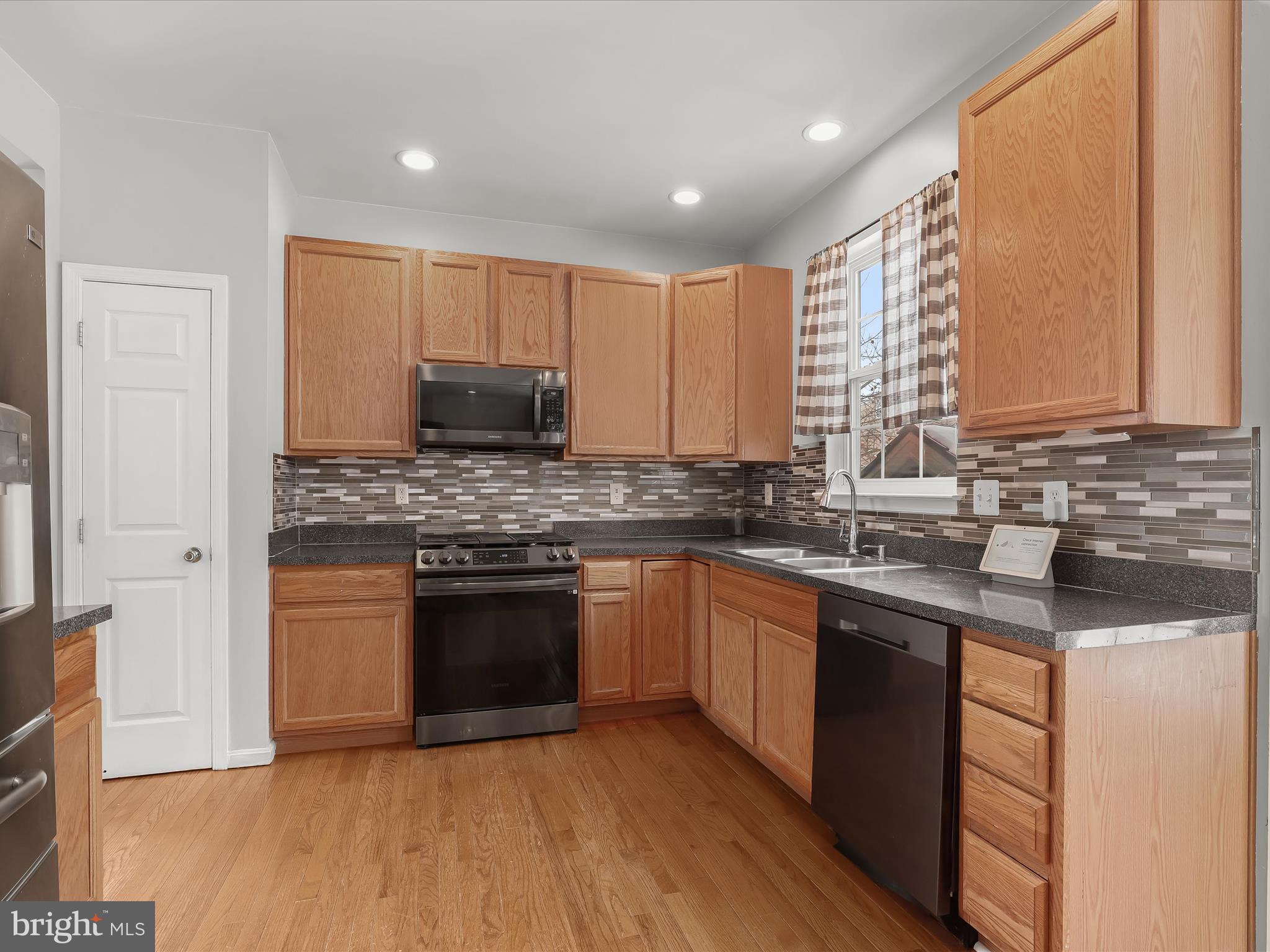 15 Dunmore Drive Hanover, PA 17331 - Photo 14 of 40 a kitchen with stainless steel appliances granite countertop a stove a sink dishwasher and a microwave oven with wooden floor
