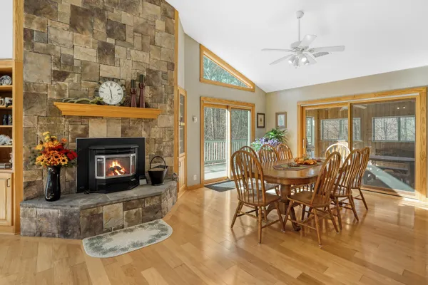 a view of a dining room with furniture water view and large windows