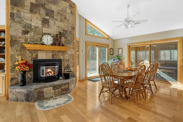 a view of a dining room with furniture water view and large windows